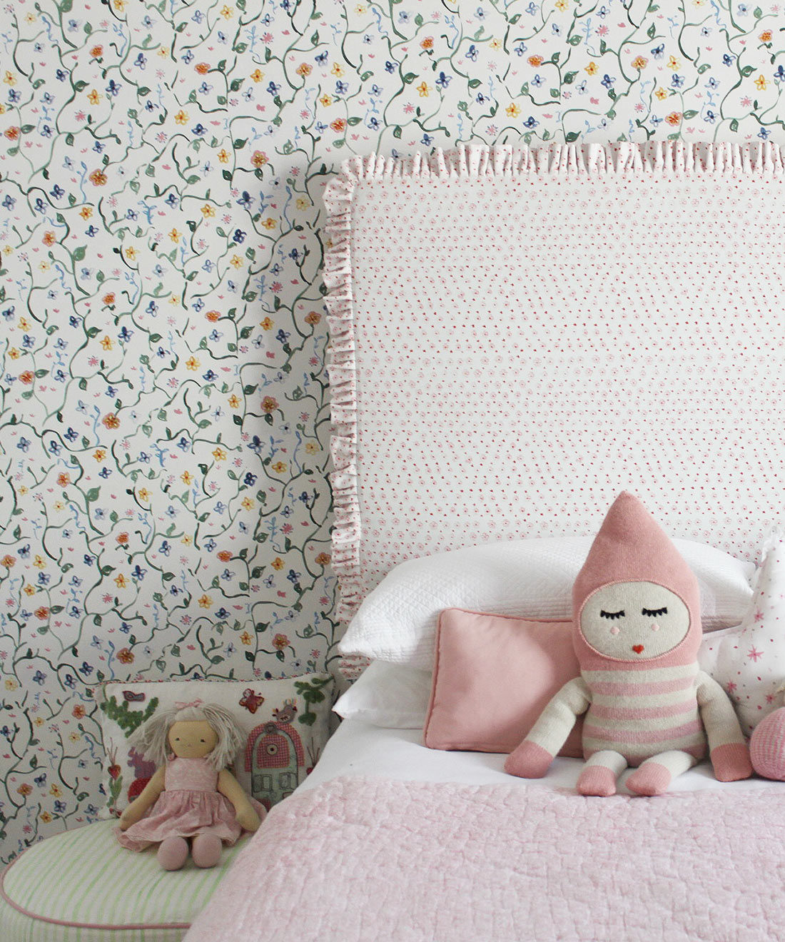 Wild Garden • Dainty Floral Wallpaper • Milton & King Europe • Georgia MacMillan • Childrens Wallpaper • Nursery Wallpaper • Bed with pink headboard and pink duvet