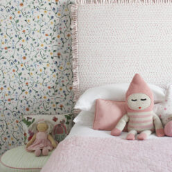 Wild Garden • Dainty Floral Wallpaper • Milton & King Europe • Georgia MacMillan • Childrens Wallpaper • Nursery Wallpaper • Bed with pink headboard and pink duvet