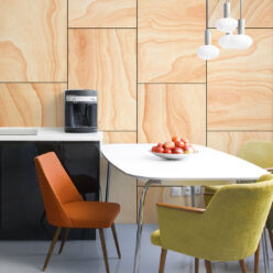 Ply Wood Wallpaper • Light Brown Wallpaper • Wood Grain Wallpaper with a white table surrounded by a green chair and an orange chair