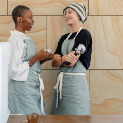 Ply Wood Wallpaper • Light Brown Wallpaper • Wood Grain Wallpaper with two co-workers conversing
